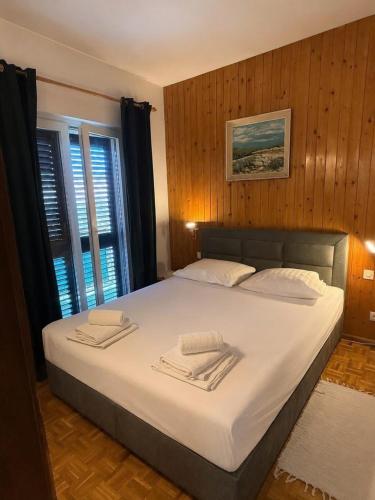 a bedroom with a large bed with two towels on it at Green Quiet Apartments in Vodice