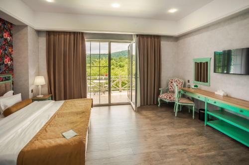 a hotel room with a bed and a desk at Macara Village Resort in Quba