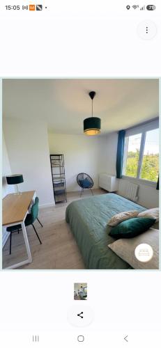 a bedroom with a bed and a table and a desk at Le Jean Jaurès in Nîmes