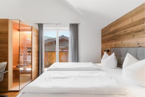 a bedroom with two beds and a large window at Appartementhaus Reiter in Altenmarkt im Pongau