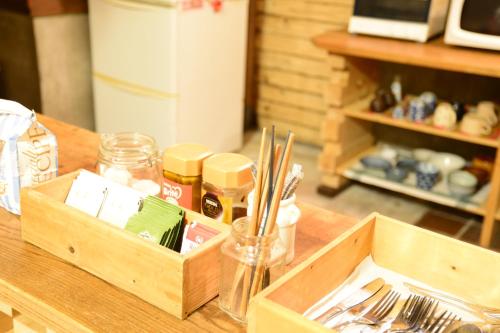 a wooden box sitting on a table with utensils at The Deer Park Inn in Nara