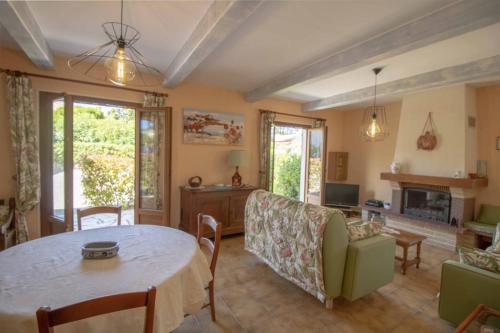 a living room with a table and a couch at Large Spacious House In Fréjus in Fréjus