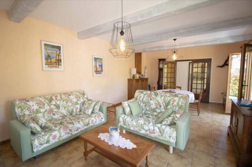a living room with two couches and a table at Large Spacious House In Fréjus in Fréjus