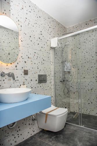 a bathroom with a toilet and a sink and a shower at Wind Alasata in Çeşme