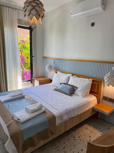a bedroom with a large bed with two towels on it at Wind Alasata in Çeşme
