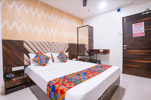 a bedroom with a large white bed in a room at FabHotel Elvis International in Mumbai