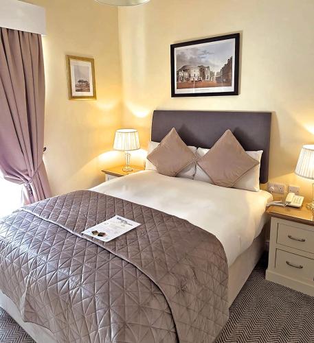 a hotel room with a large bed and two lamps at Waterloo Lodge in Dublin
