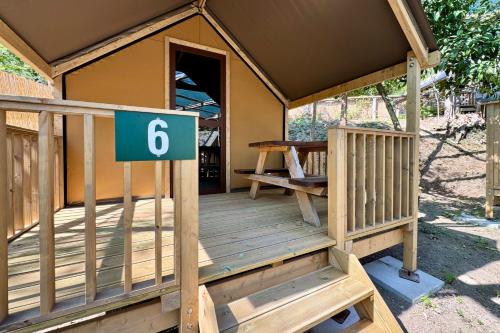 a porch of a house with a sign on it at Hostel & Glamping Santa Fortunata in Sorrento