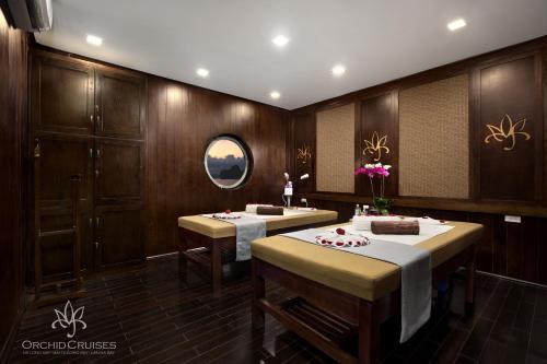 a dining room with two tables with food on them at Orchid Classic Cruise in Ha Long