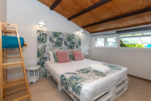 a bedroom with a bed and a ladder in it at Mermaid Cove - Blue Bay in Blue Bay