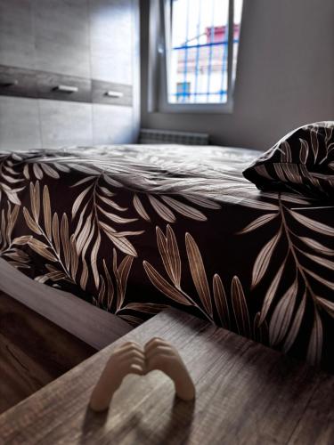 a bed with a blanket with a pair of hands at Villa Calhia in León