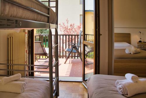 a bedroom with two bunk beds and a balcony at Barzio Coldogna 5 in Barzio