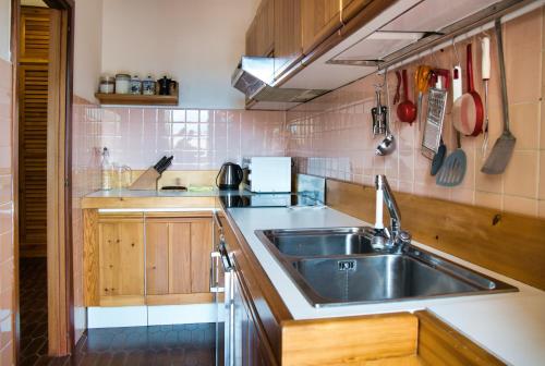 a kitchen with a stainless steel sink and wooden cabinets at Barzio Coldogna 5 in Barzio