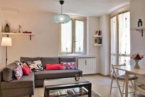 a living room with a couch and a table at Alpine studio Barzio in Barzio