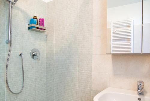 a bathroom with a shower and a sink at Alpine studio Barzio in Barzio