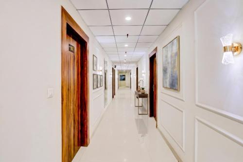 a corridor of a hospital with white walls at FabHotel The Elegant - 150 Meters From Delhi Public School Meerut in Anūpnagar