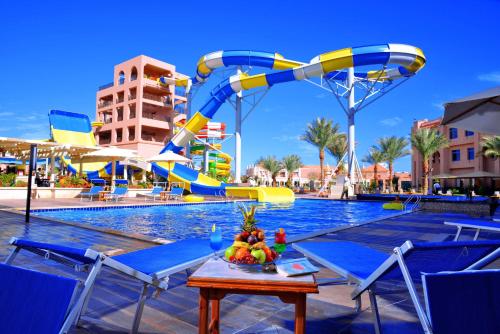 a pool with a water slide at a resort at Pickalbatros Aqua Park Resort - Hurghada in Hurghada