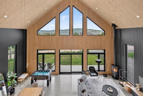 a living room with large windows and a couch at Panoramic View - Spa - L'Espace-temps in Saint Come