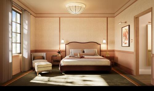 a bedroom with a large bed and a chair at The Nora Hotel in West Palm Beach
