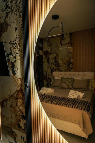 a mirror reflection of a bed in a room at Artion Suites Nikiti in Nikiti