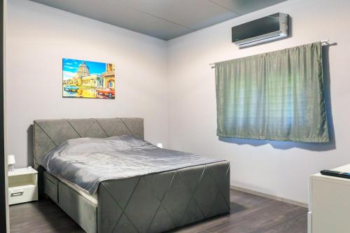 a small bedroom with a bed and a window at Pablo's place in Rezine