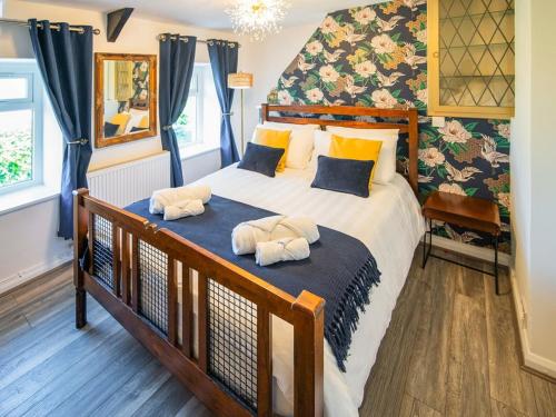 a bedroom with a large bed with two pillows at 4 Bed in Dothan Ty Croes oc-m44701 in Llanfaelog
