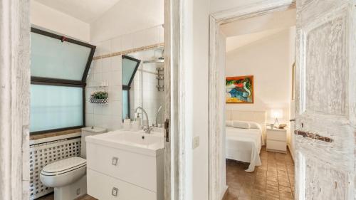 a white bathroom with a sink and a toilet at VILLA ALTHAEA 6, Emma Villas in Orbetello
