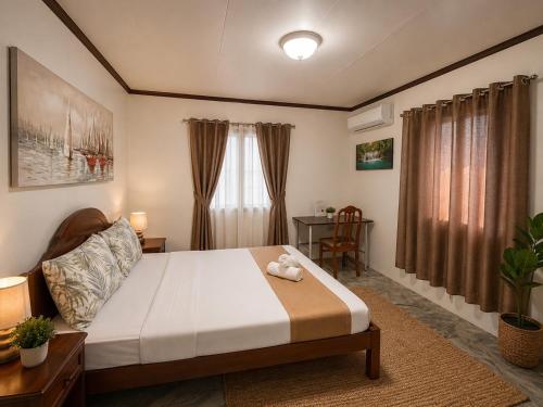 a bedroom with a bed with a teddy bear on it at Dreamcatcher Hostel in Moalboal