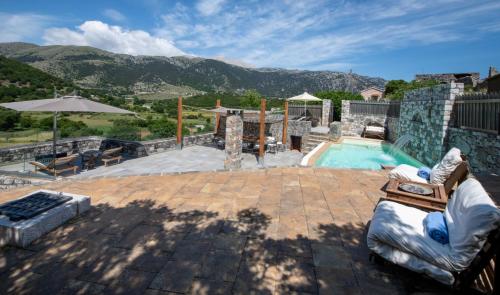 a backyard with a swimming pool and a patio at Traditional Villas Askyfou in Karés