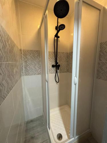 a shower with a glass door in a bathroom at Le Lotus - 5 in Cherbourg en Cotentin