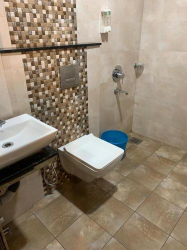 a bathroom with a toilet and a sink at Peace Residency in Jāmb