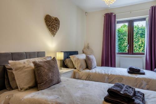 a living room with two beds and a window at 2 Bed in Buxted oc-t44744 in Buxted