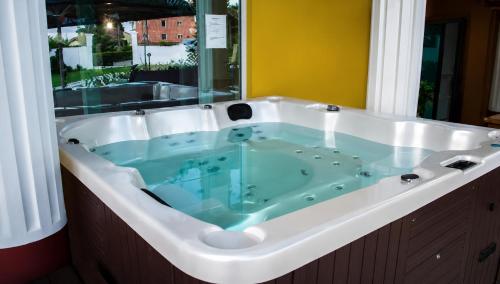 a large bath tub with a blue water in it at Aleksov Complex Aleksion Palace in Ognyanovo