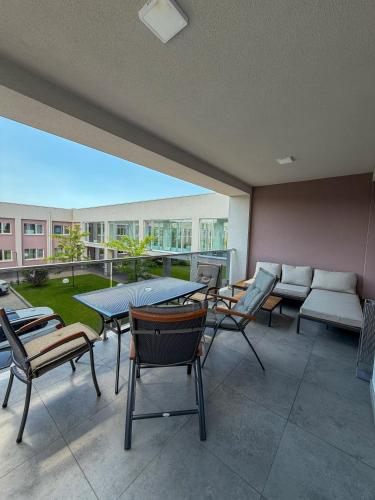 a large patio with chairs and a table and a couch at Спа-готель ПОЛО-МЕДЛАЙФ in Kremenchuk