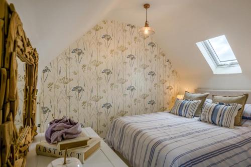 a bedroom with a bed with a floral wallpaper at 2 Bed in Docking oc-t44851 in Docking