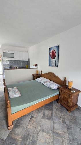 a bedroom with a large bed and a table at Xigga apartments in Donji Stoliv