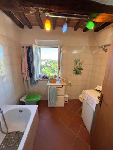 a bathroom with a tub and a sink at Casa Didi in Cetona