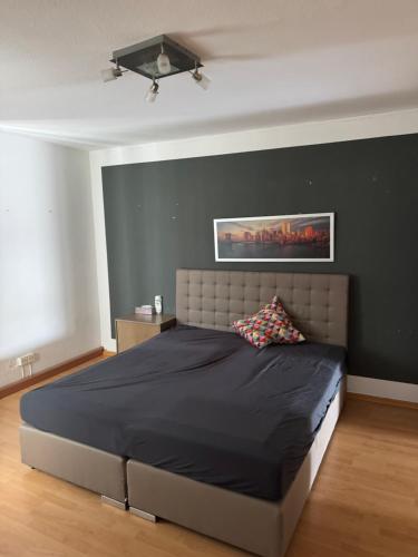 a bedroom with a large bed with a black wall at Marivel Wohnung in Freudenstadt