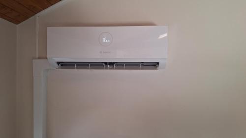 a white stove top oven sitting on top of a refrigerator at La tête dans les étoiles - Appartement climatisé - 2 Chambres in Ruffec