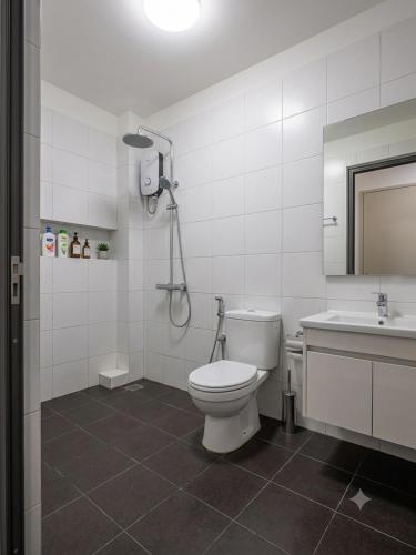 a bathroom with a toilet and a sink and a shower at Hammer Homestay in Danang