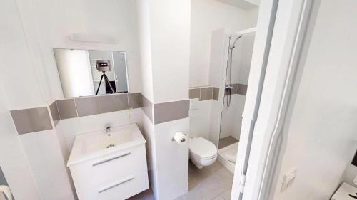 a bathroom with a toilet and a sink and a mirror at HÔTEL Relais de Monti in Menton