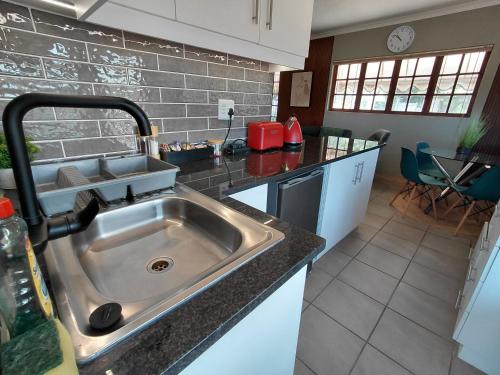 a kitchen with a sink and a counter top at Executive Flat with Stunning Views in Westville