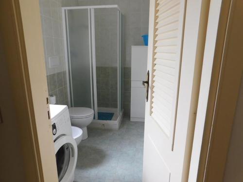 a bathroom with a toilet and a glass shower at Residenze Sant'Andrea in Isca Marina