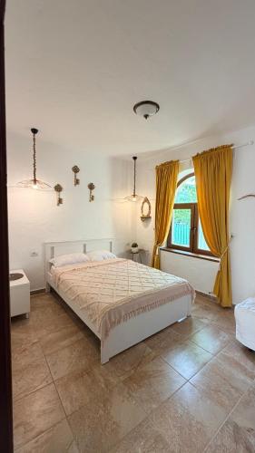 a bedroom with a large bed and a window at Casa YMA in 2 Mai