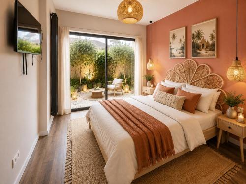 a bedroom with a large bed and a large window at Villa Confidentielle Opale in Merlimont