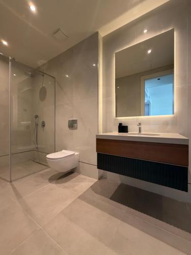 a bathroom with a toilet and a sink and a mirror at BW Perla - Premium Apartments in Belgrade