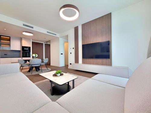 a living room with a white couch and a table at BW Perla - Premium Apartments in Belgrade