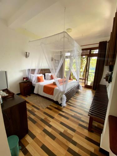 a bedroom with a bed with a canopy at Ameliora Ella in Ella
