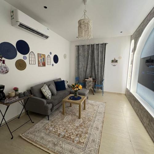 a living room with a couch and a table at Greek Home4 in Al Khobar