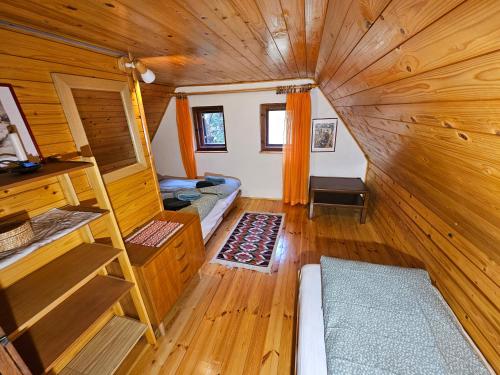 a tiny house with a room with a staircase at Hiška Polhec in Bovec